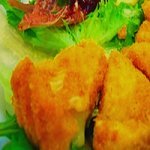 Deep fried Camembert cheese wedges on lettuce