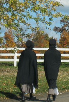 2 Amish girls dressed in their traditional Amish clothes