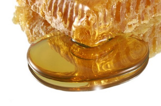 honey escaping from the raw honey comb