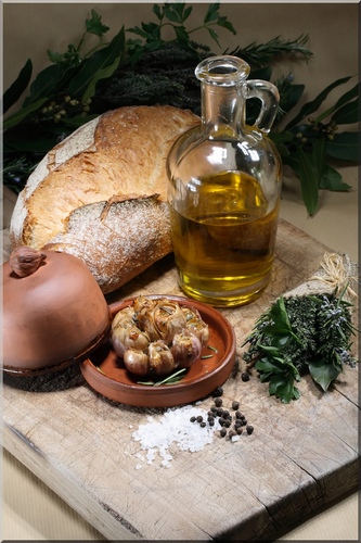 bread, olive oil, shallots and herbs on a wooden cutting board