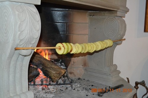 Drying apple rings in front of the fireplace.