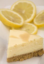 lemon cheesecake with sliced lemons in the background
