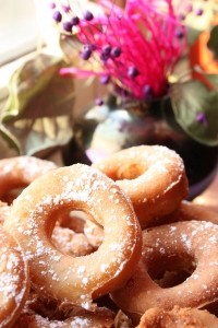 Maple donuts in a pile on a plate.