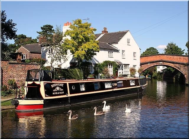 A narrowboat on a river in Cheshire