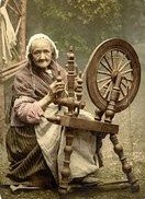 An old lady at a spinning wheel