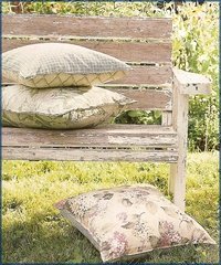  An old cottage bench with some printed cushions