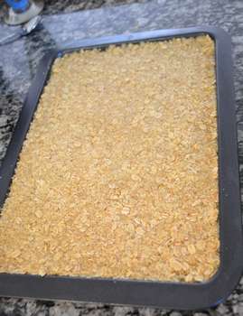Oat mixture well flattened in baking tray.