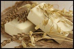 2 bars of goats milk soap sitting on hessian