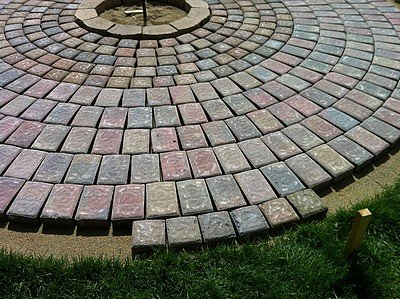 Placing the last row of patio pavers.