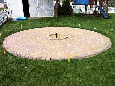 Brushing pavers with sand.