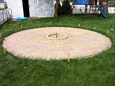 Brushing pavers with sand.