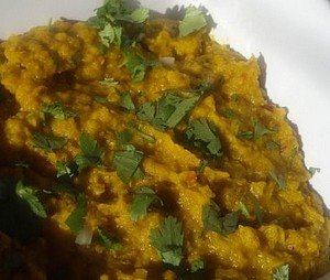 A plate of pumpkin and lentil curry.