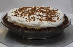Pumpkin chiffon pie with cream and cinnamon.