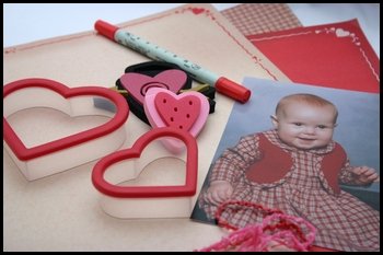 scrapbooking supplies with embellishments and a photo of a baby