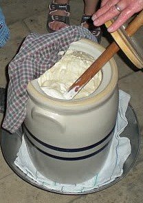 Making homemade butter with a butter churn.