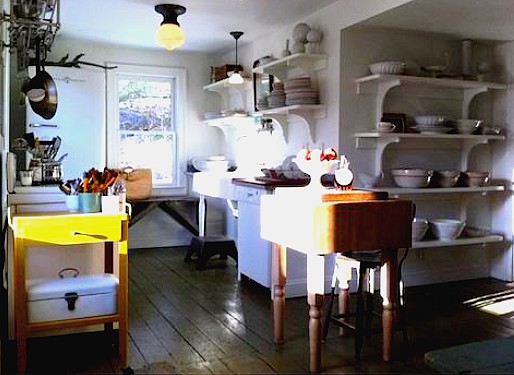 Traditional country style kitchen with basic units and wooden floor.