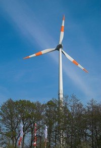 a wind turbine above some trees